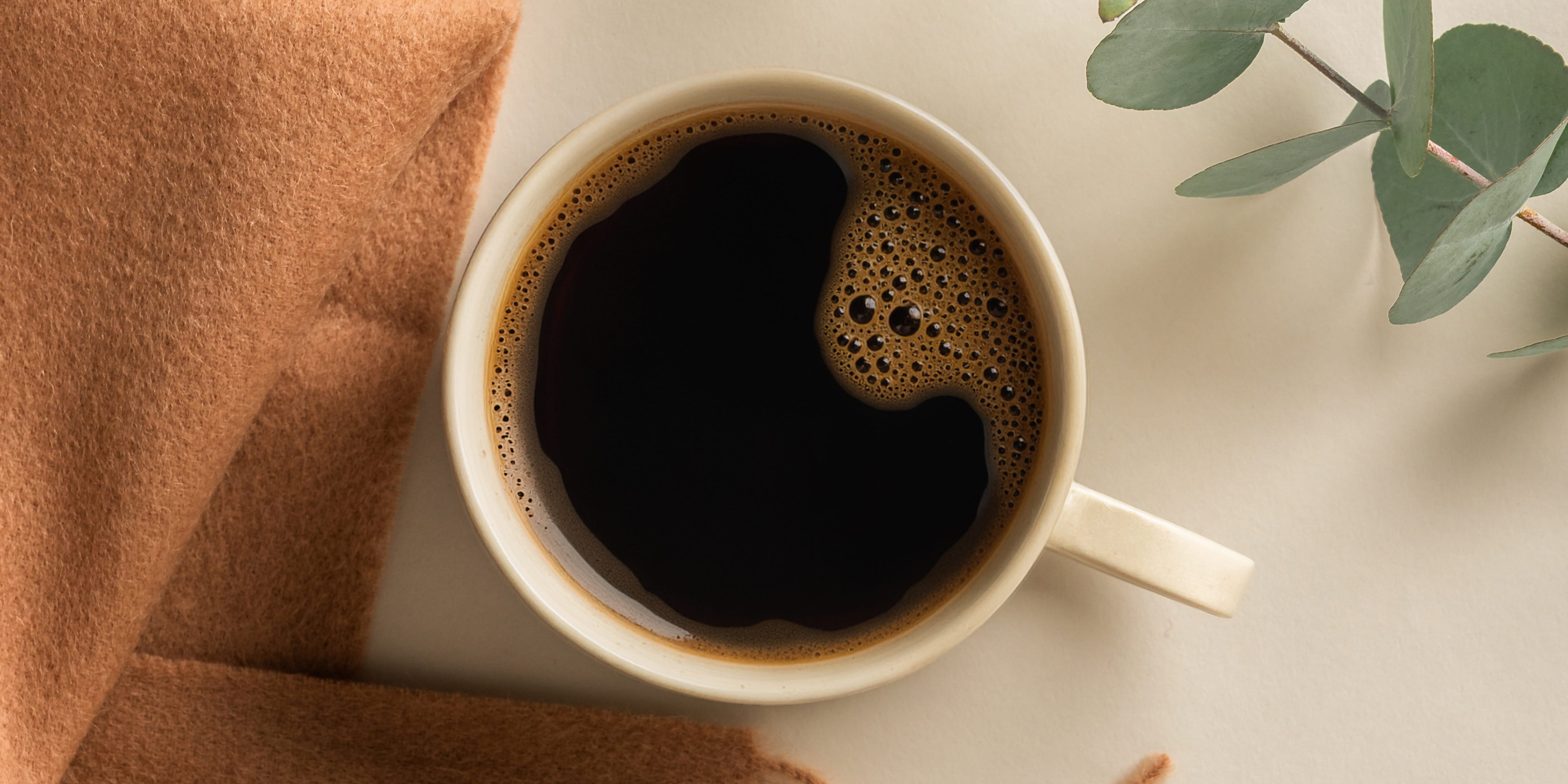 Bag of Industry Beans Autumn Filter Blend on sandstone block with glass mug of filter coffee