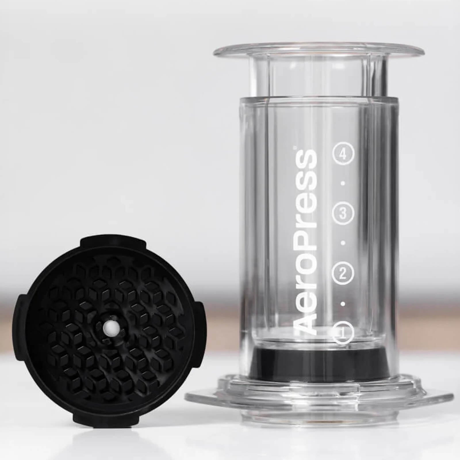 aeropress cap next to brewer