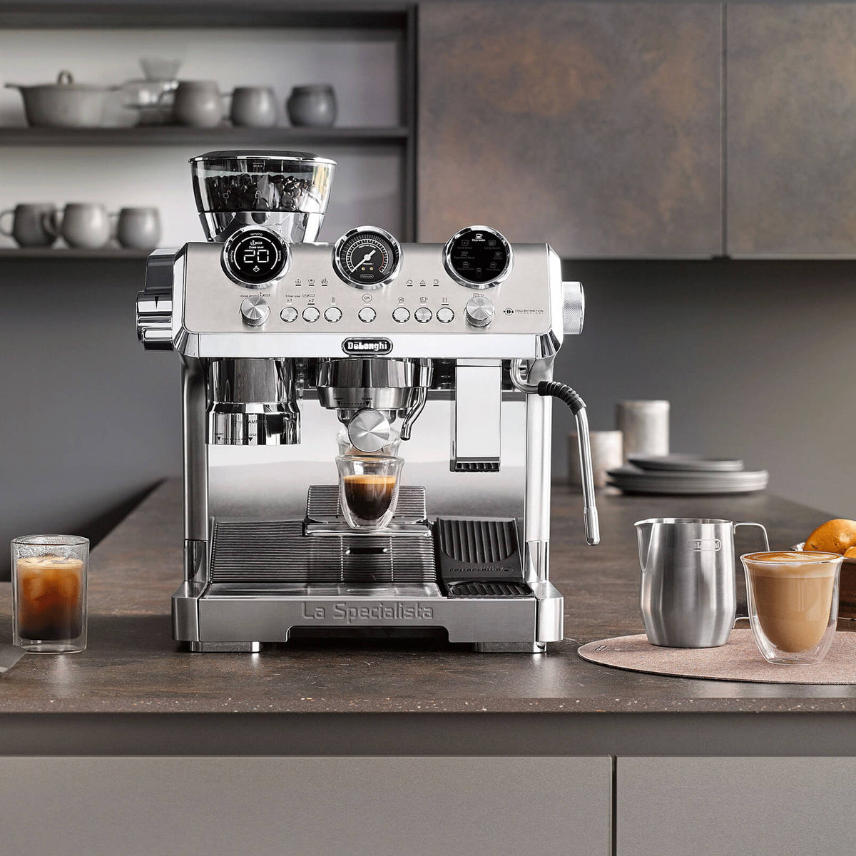 Espresso machine on a kitchen counter with various items including cups and a bowl.