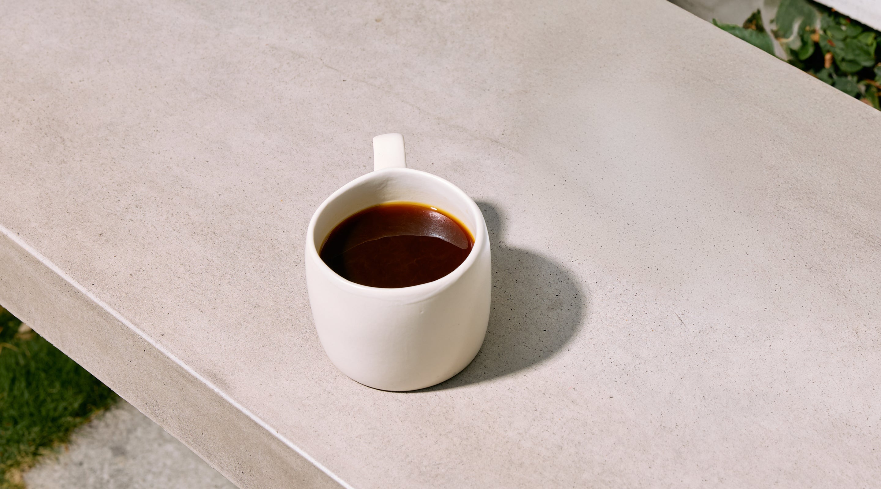 White Mug of Industry Beans Filter Single Origin Coffee on Concrete Surface