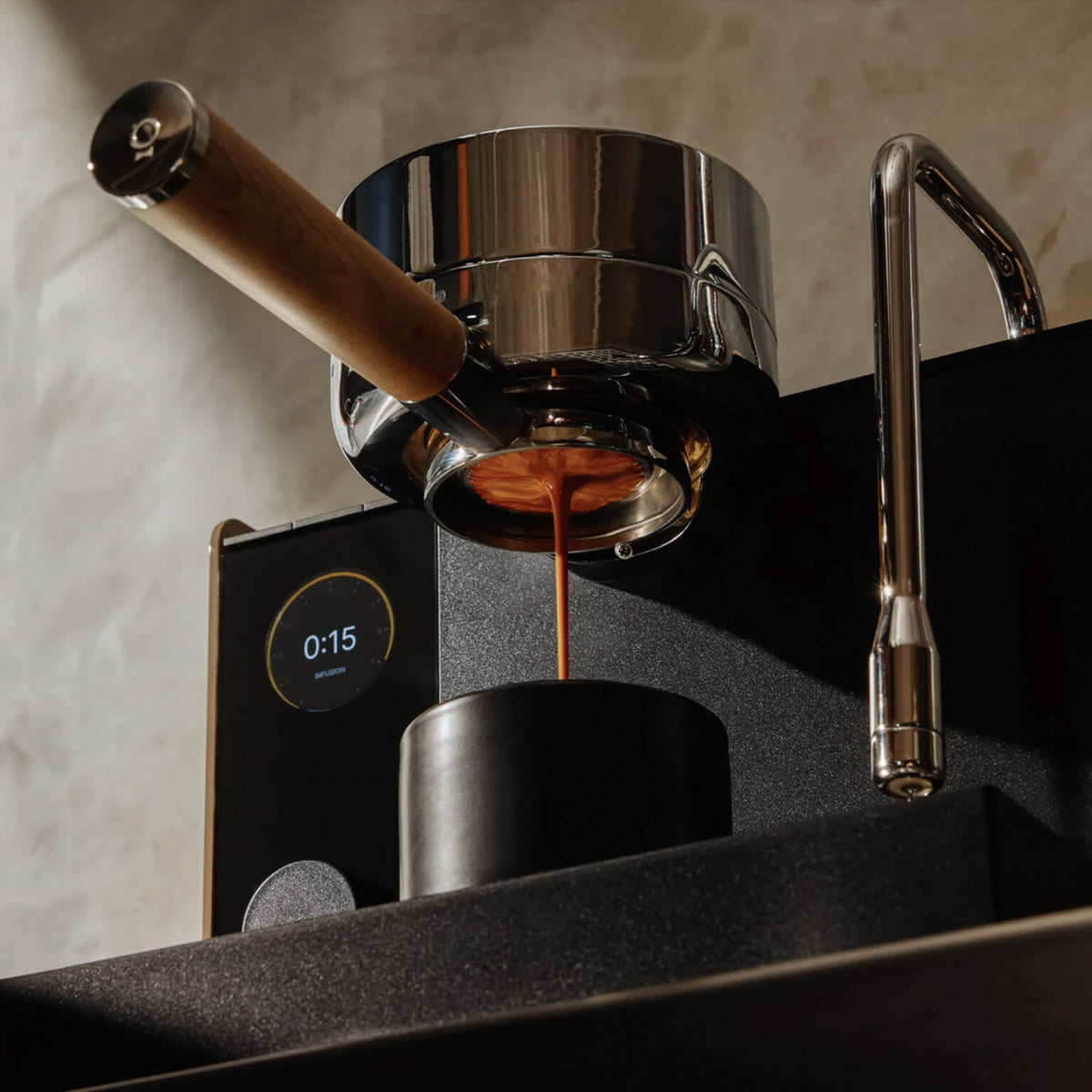 Black Fellow Espresso Series 1 espresso machine pouring an espresso shot into a cup, low-angle view
