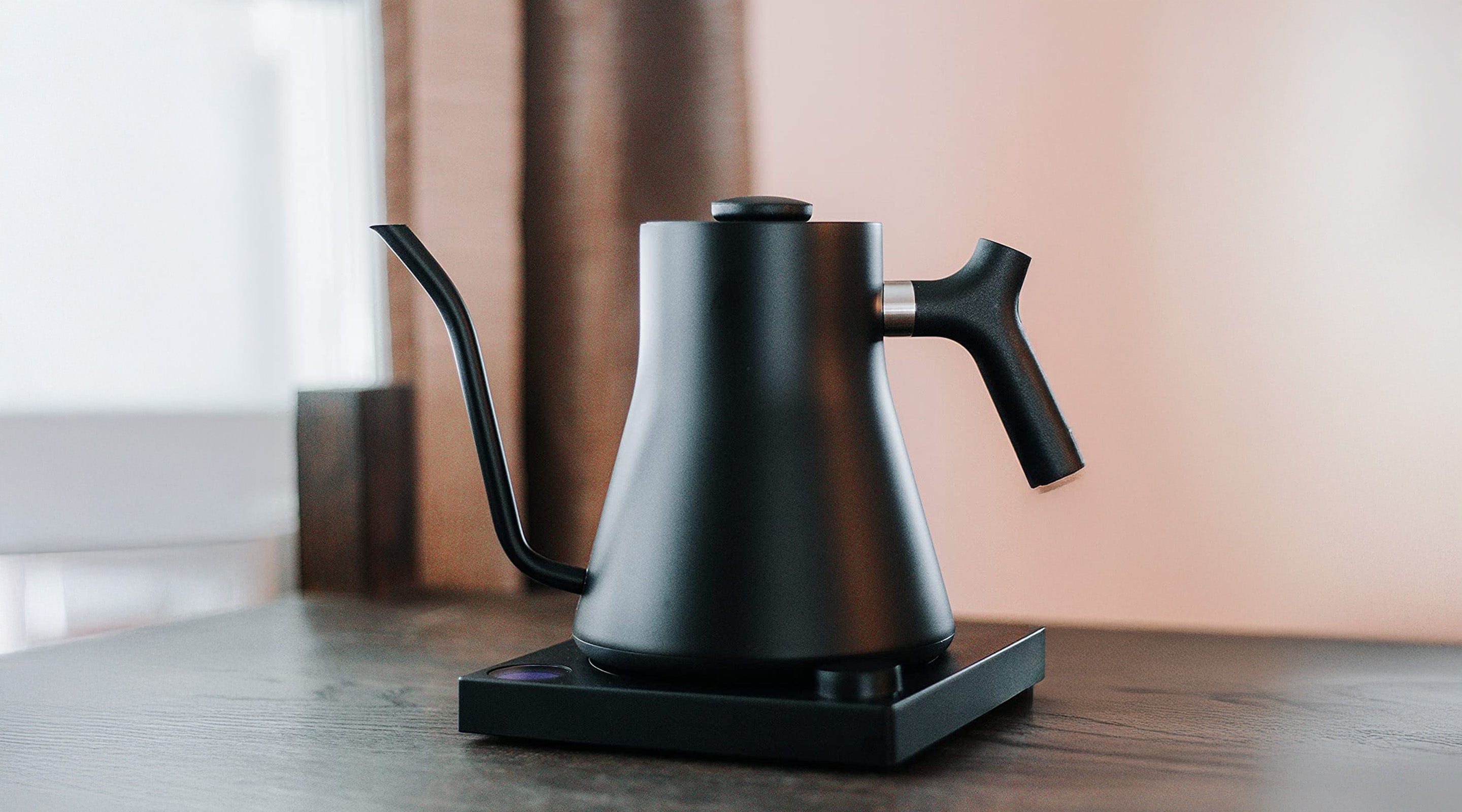 Matte Black Fellow Stagg EKG Pro Electric Kettle on wooden bench