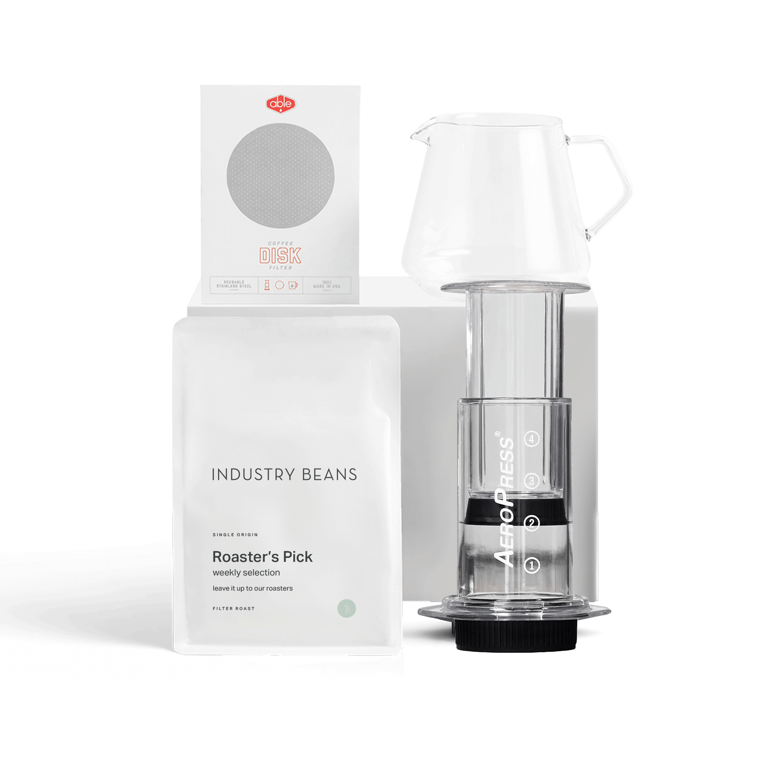 An aeropress coffee maker with a pack of 'Industry Beans' coffee