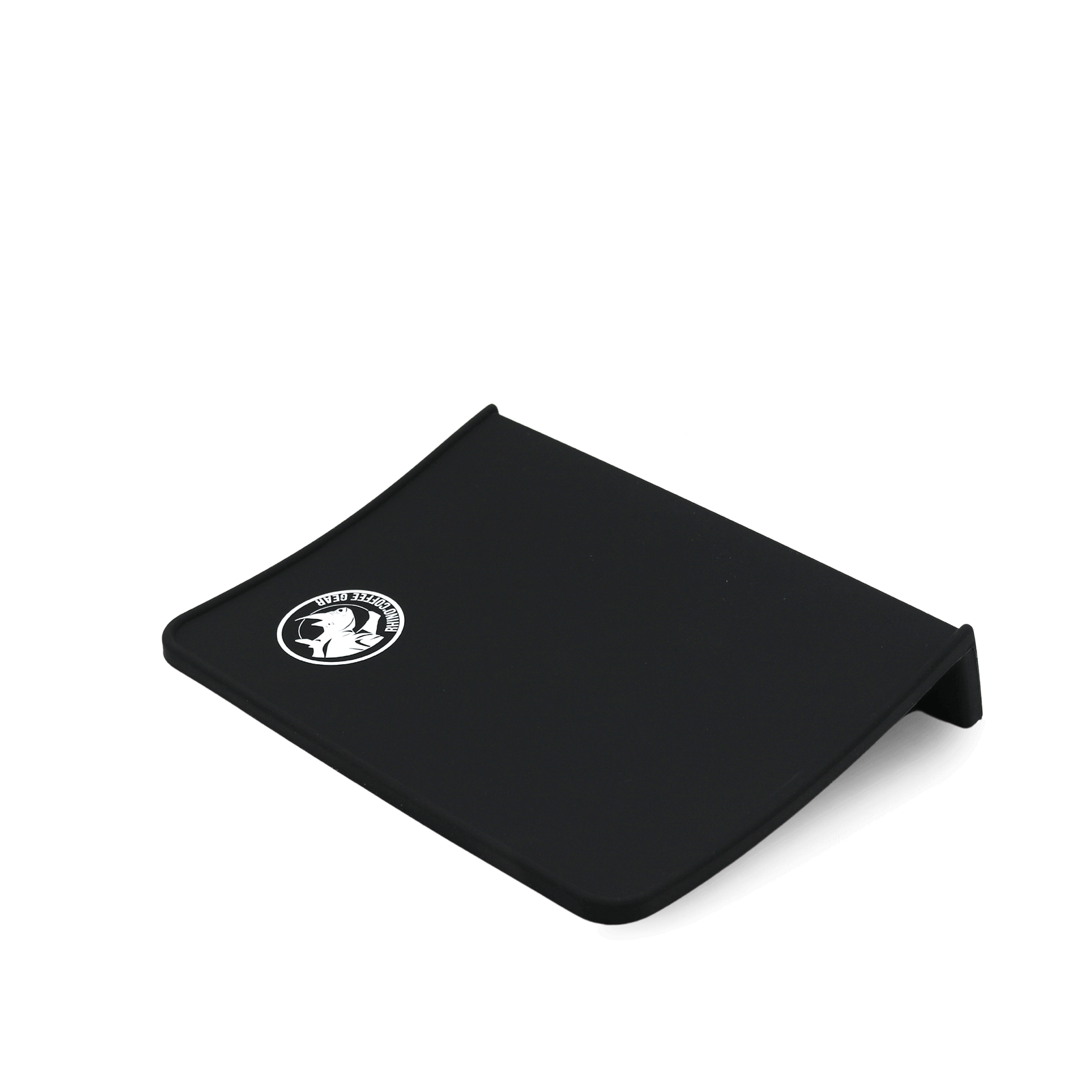 A black silicone corner tamping mat with a coffee-related logo on it, designed to fit on the corner of a countertop.