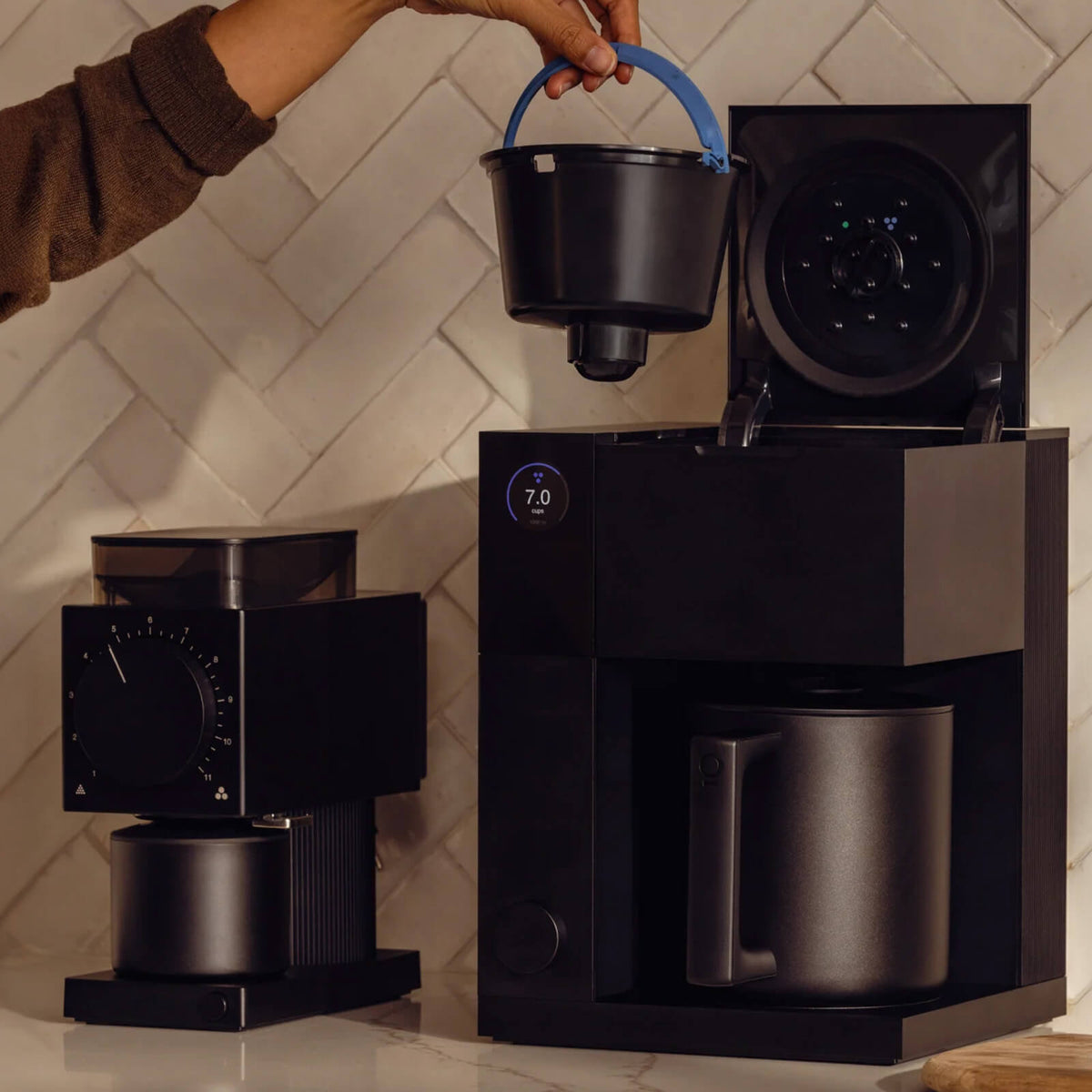 Person using a coffee maker