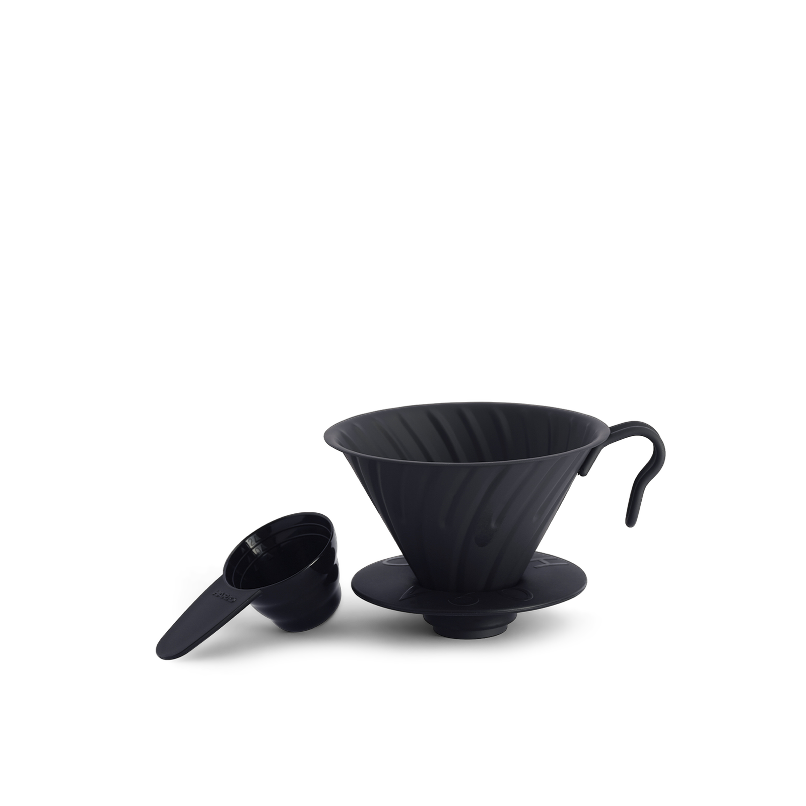 A matte black stainless steel Hario V60 Metal Pourover Dripper designed for brewing coffee, shown with a silicone base.