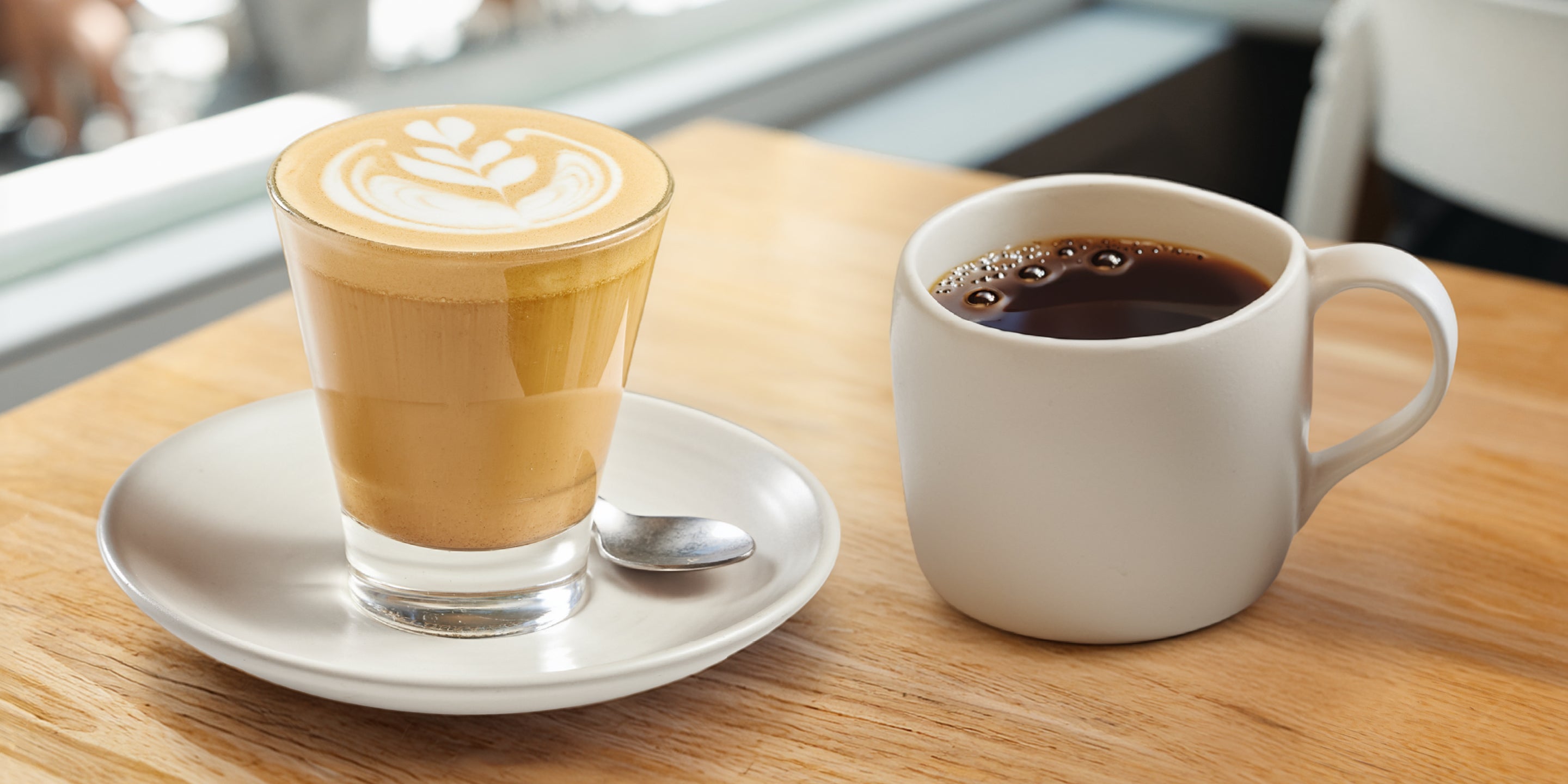 Industry Beans Specialty Coffee. Latte Glass & Filter Brew in ceramic mug sitting on wooden table