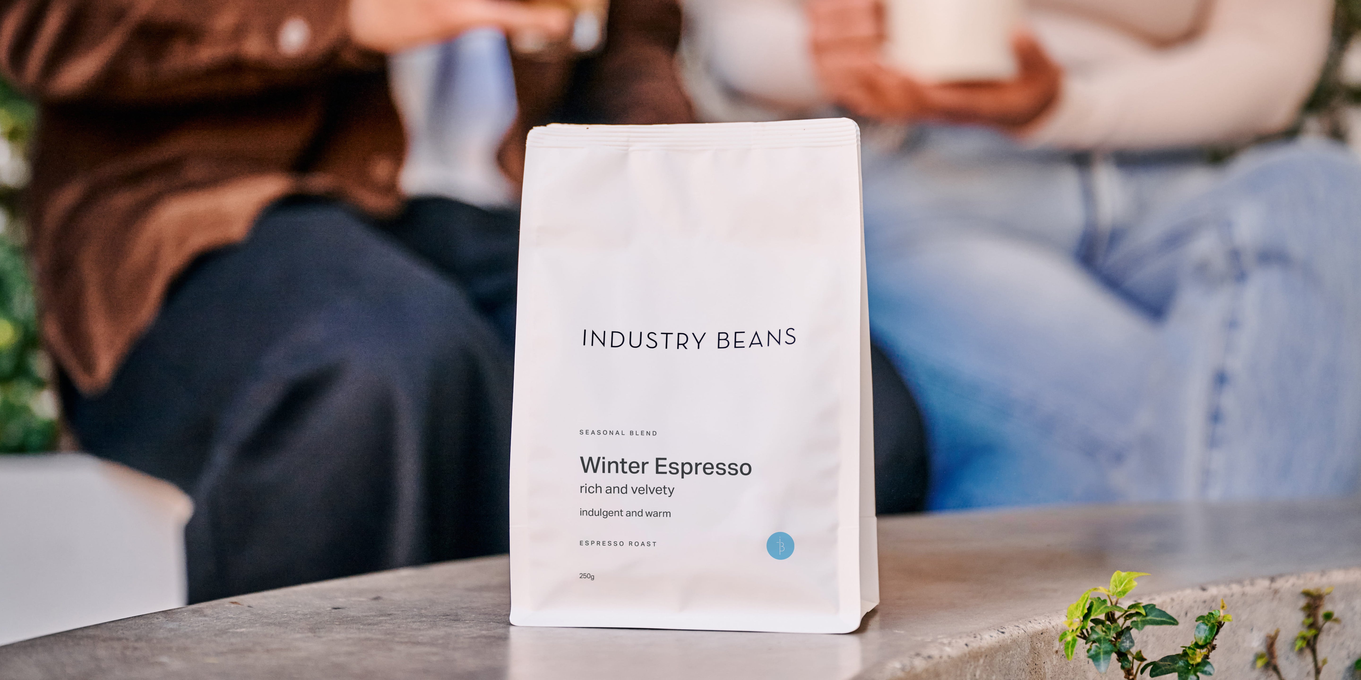 Industry Beans Specialty Coffee. Latte Glass & Filter Brew in ceramic mug sitting on wooden table