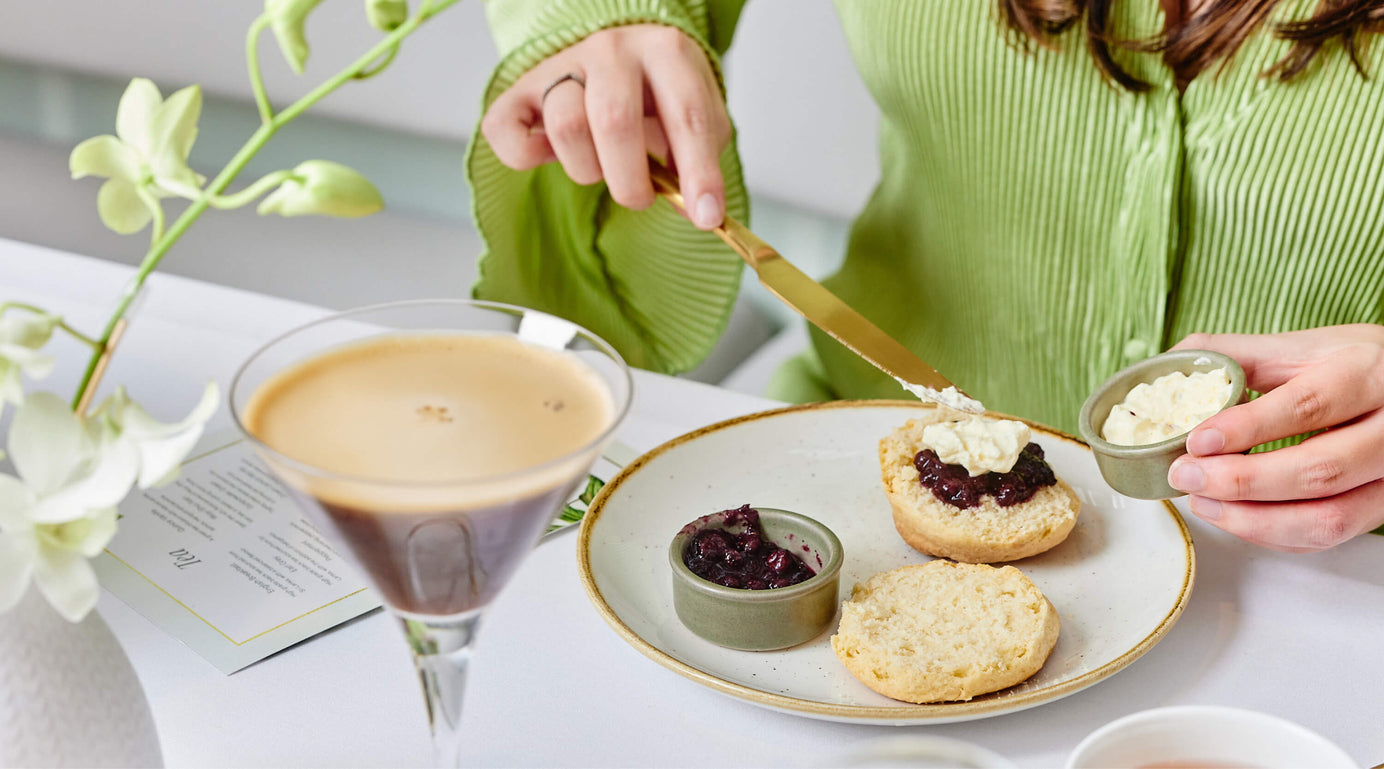 Placing Cream Onto Scone with Jam at High Tea