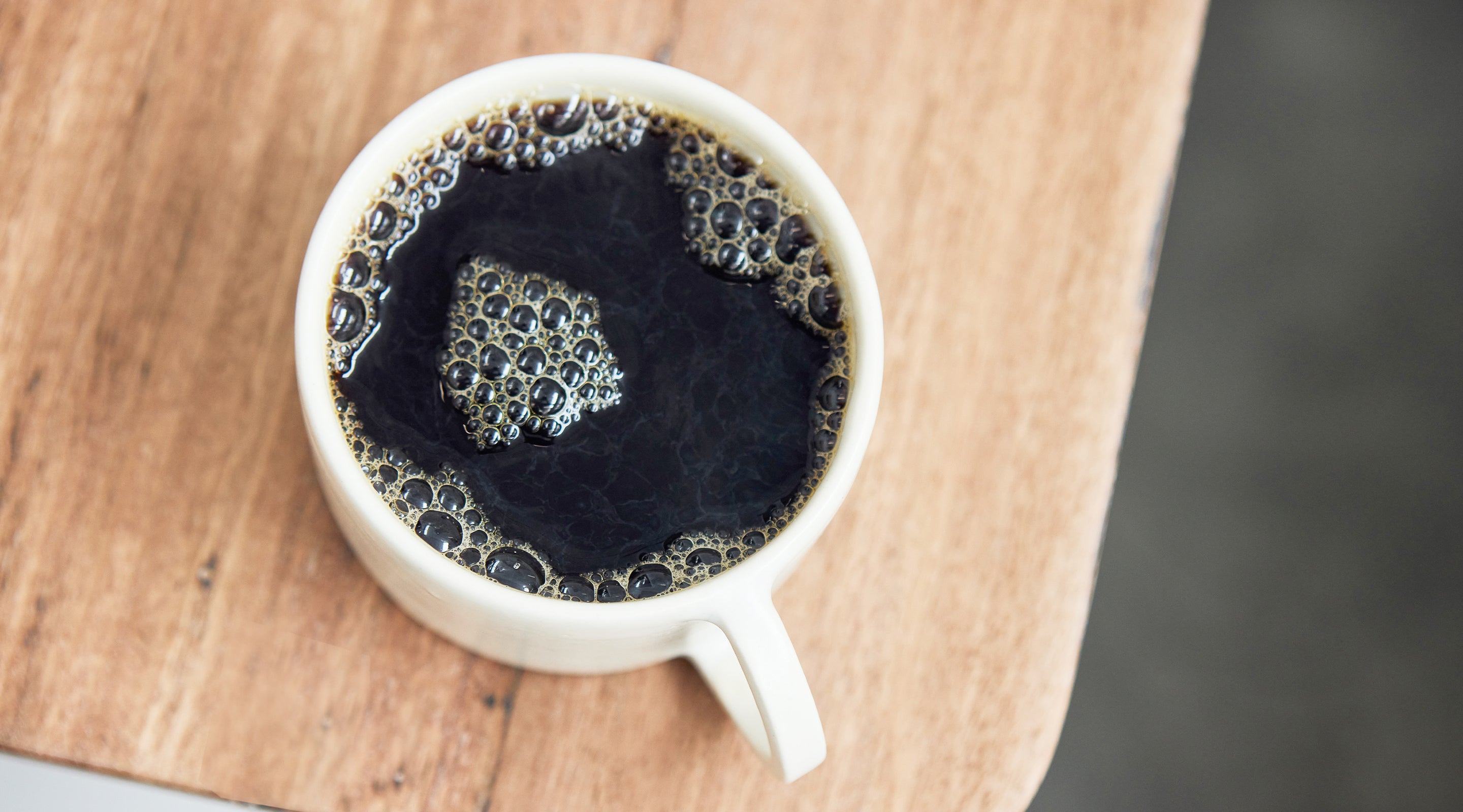 Mug of Industry Beans Filter Single Origin Coffee Against Timber Surface
