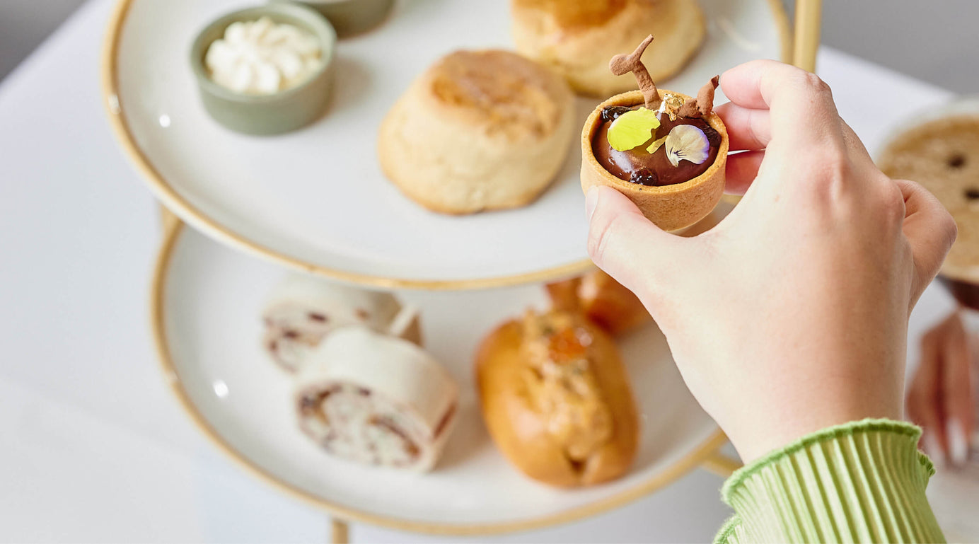 Selecting A Delicious Chocolate Treat From High Tea Assortment