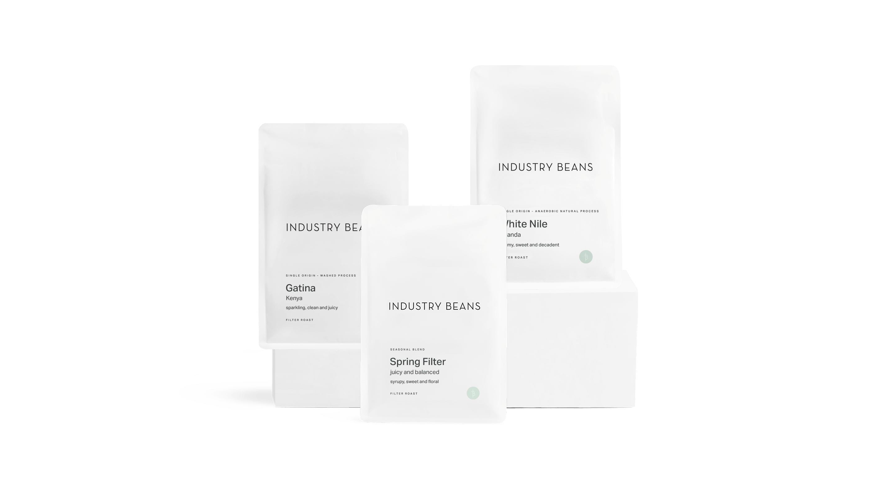 Set of coffee bags with 'Industry Beans' branding on a black background