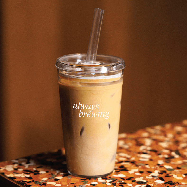 clear coffee tumbler on bench