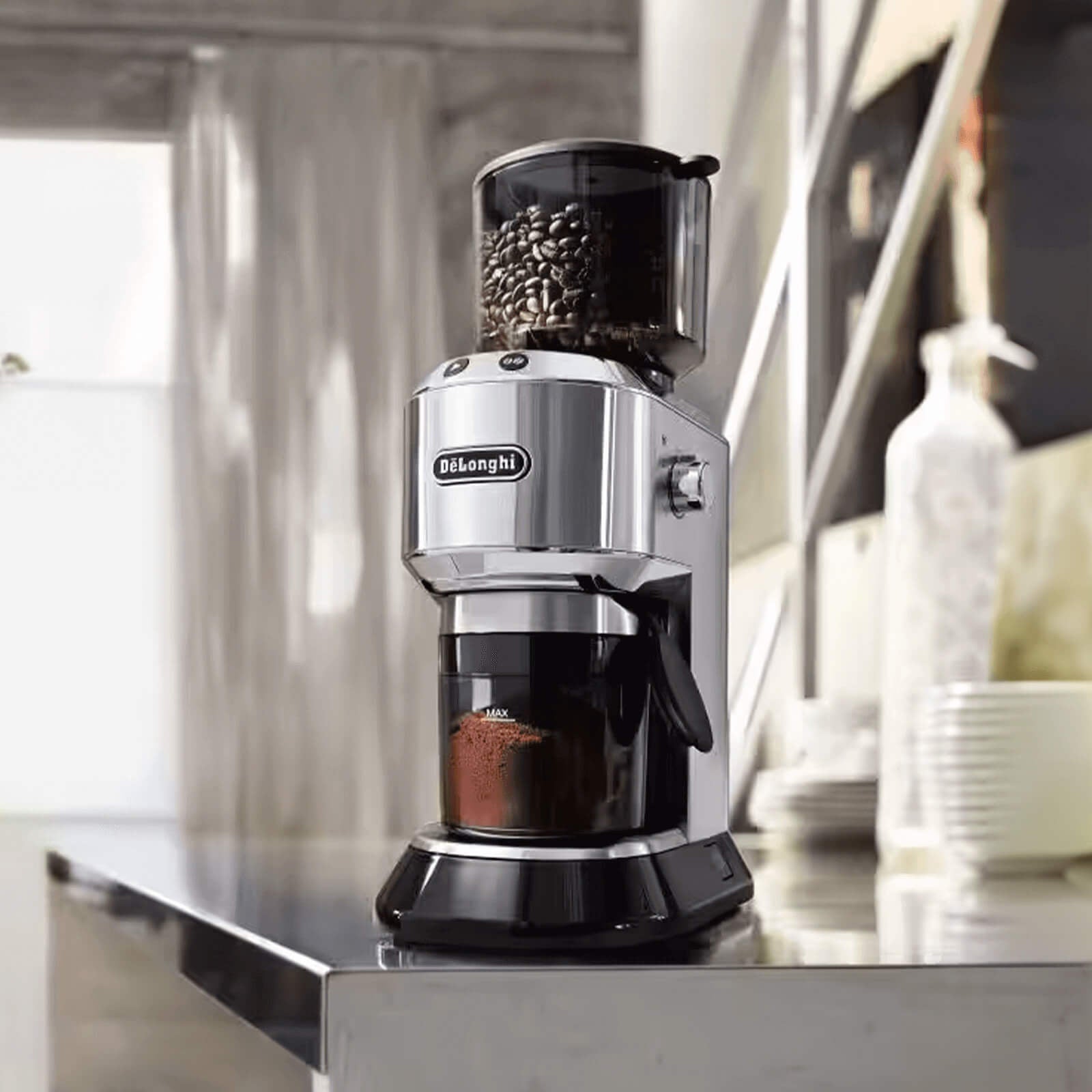 De'Longhi coffee grinder on a kitchen counter with a blurred background