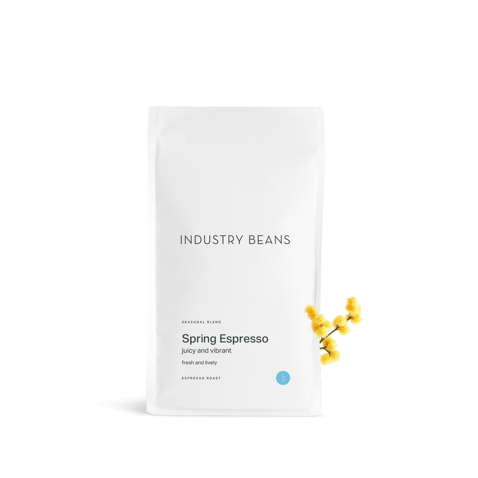 A white stand-up coffee bag labeled 'INDUSTRY BEANS' and 'Spring Espresso' with small yellow flower accents on the right side, photographed on a clean white background.